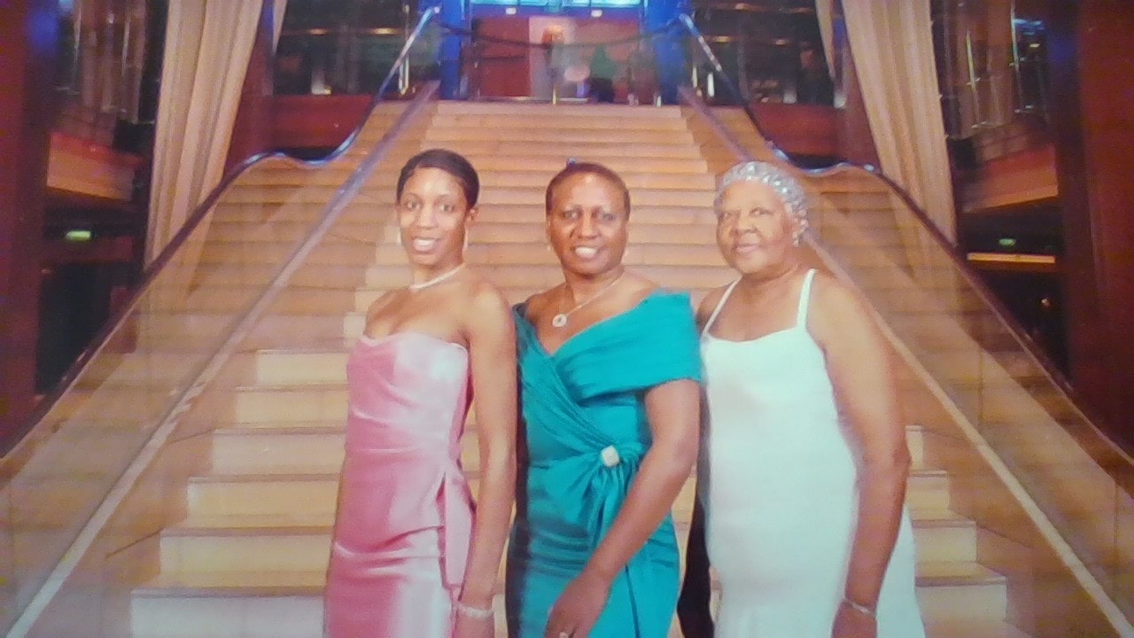 Freddie and family in formal evening gowns on a cruise ship grand staircase