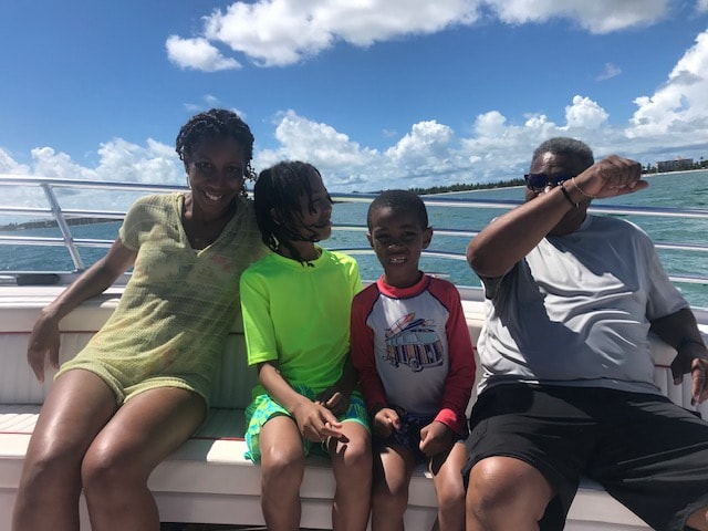Freddie with her family sitting together on a boat out on the water